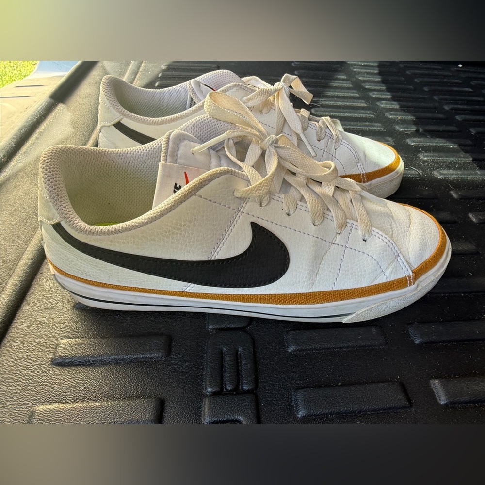 Nike White Sneakers with Black Swoosh and Gold Accent